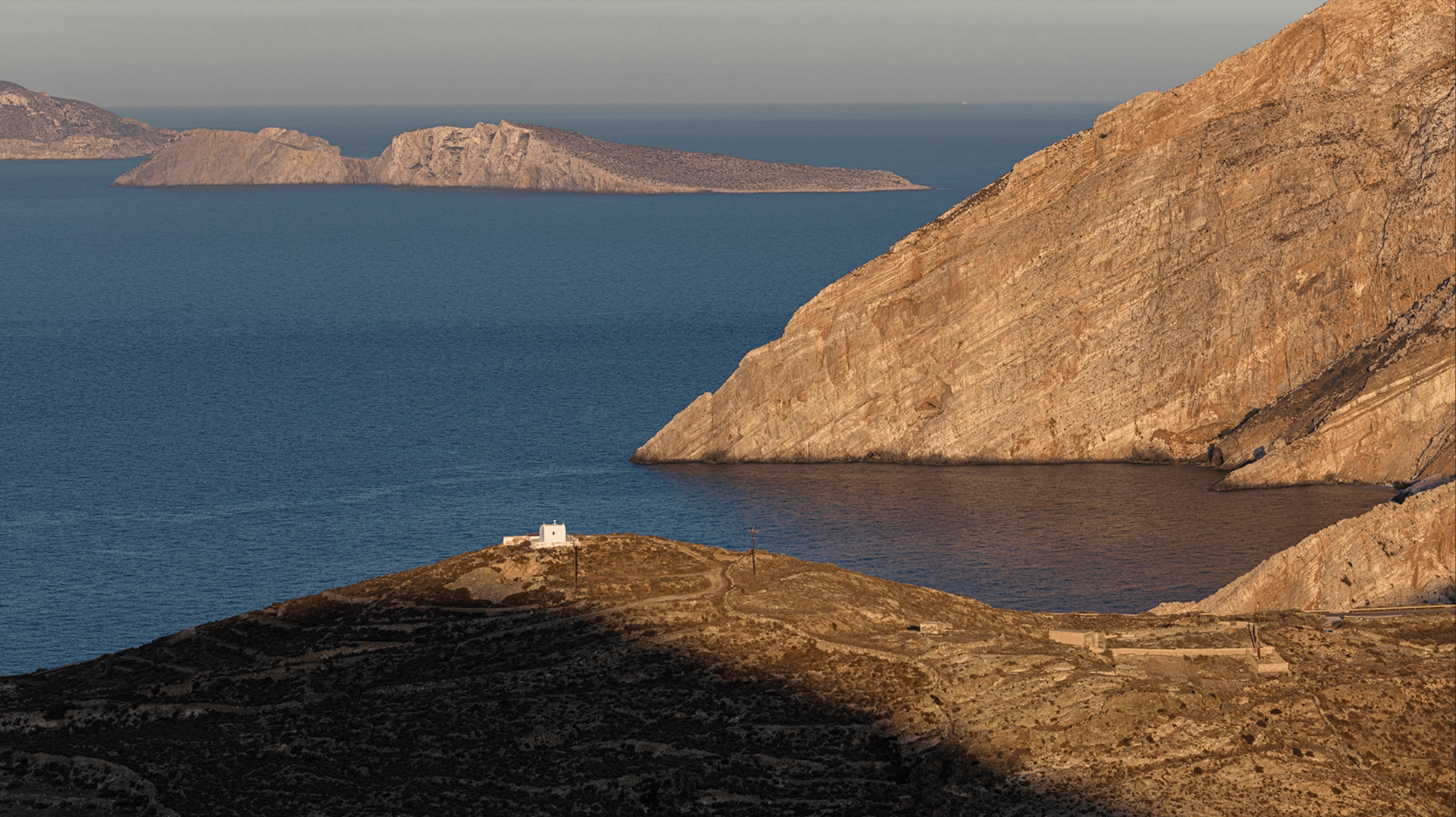 A pear set on a yellow plate upon a soft white canvas texture.